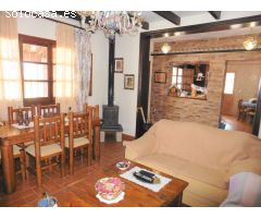 Chalet con porche, piscina y barbacoa.