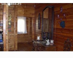 PARCELA CON CASA DE MADERA- Parcela de terreno de 3000 m2 y casa madera maciza amueblada de 135 m2