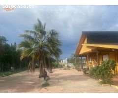 CHALET DE MADERA CON PISCINA Y JARDINES EN PARCELA VALLADA.